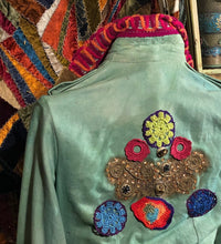 Load image into Gallery viewer, Back of jester&#39;s jacket embellished with embroidered appliques and whimsical designs
