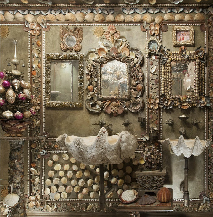 Bath reimagined as a shell grotto, with giant clam sinks; shell wall art; shell-covered walls.