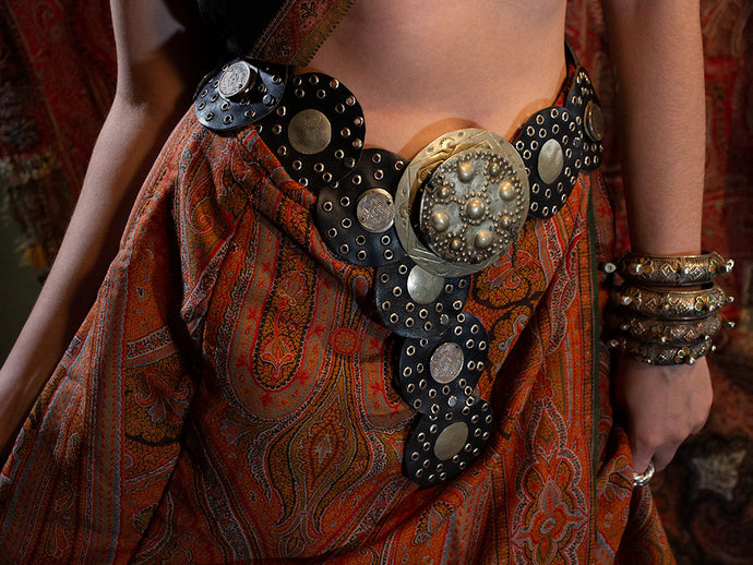 Model wearing leather belt featuring antique Moroccan silver coins