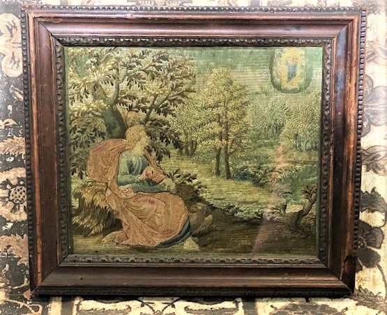 Embroidered scene of the virgin appearing in the clouds to a person seated under a tree.