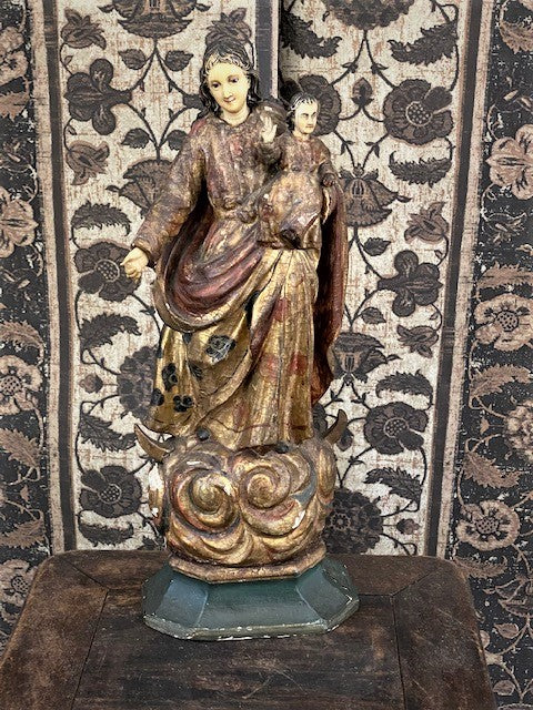 Front view of carved statue showing painted features.