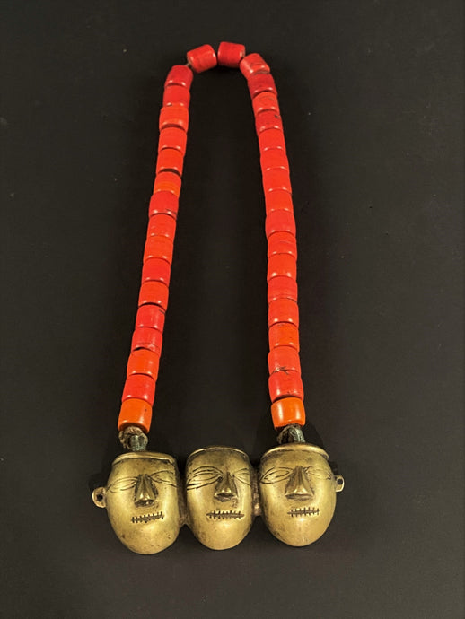 Three-headed brass pendant on orange tile bead necklace.Naga