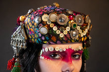Load image into Gallery viewer, Upcycled vintage pillbox hat maximalized with heirloom mother-of-pearl  buttons, silver Afghan clothing ornaments, antique Pashtun silver triangular ornaments and Afghani tent band tassels with silver.
