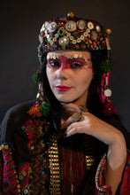 Load image into Gallery viewer, Upcycled vintage pillbox hat maximalized with heirloom mother-of-pearl buttons, silver Afghan clothing ornaments, antique Pashtun silver triangular ornaments and Afghani tent band tassels with silver.
