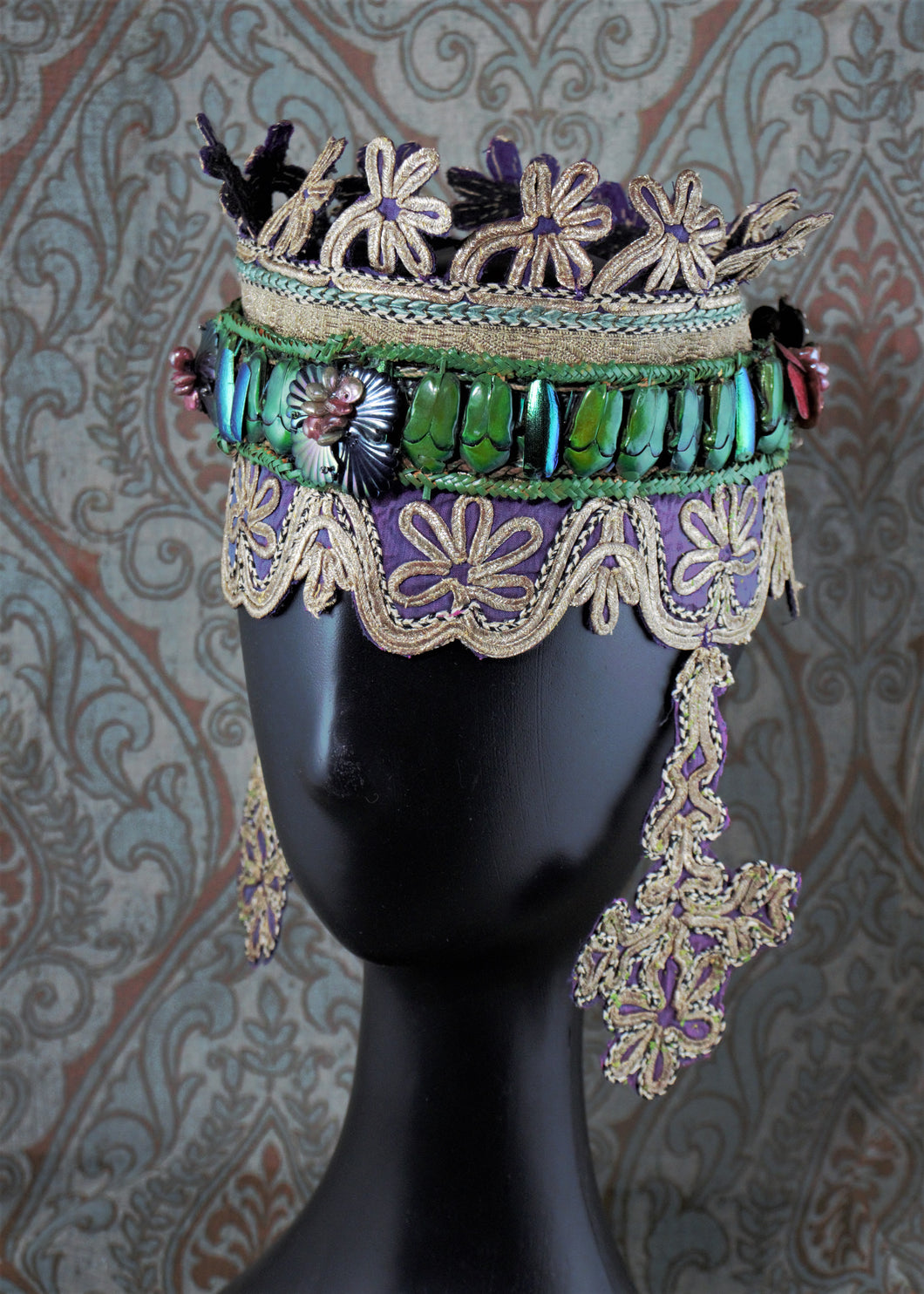 Front view of Lady of Shallot headdress decorated with iridescent bug carapaces and floral 