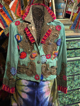 Load image into Gallery viewer, Highly-decorated maximalist jester&#39;s jacket embellished with gold thread embroidery, embroidered flowers, and silk trims.
