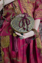 Load image into Gallery viewer, Brass Sufi Kashkul evening bag, held by model.
